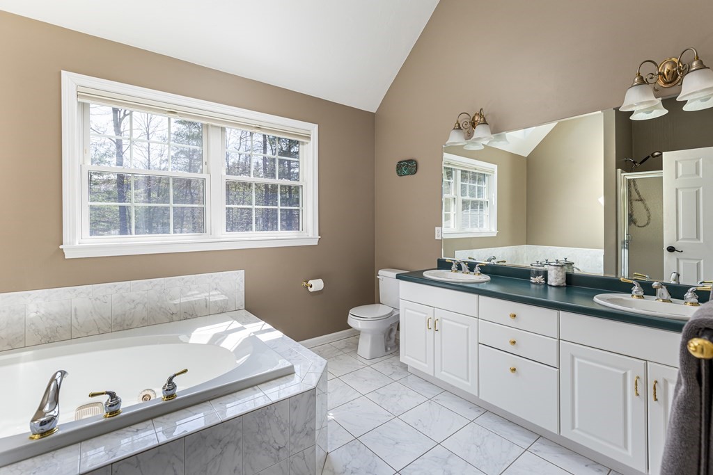 23 Pennock Road Ashland, MA 01721 - Photo 29 of 41 a spacious bathroom with a granite countertop sink and a bathtub