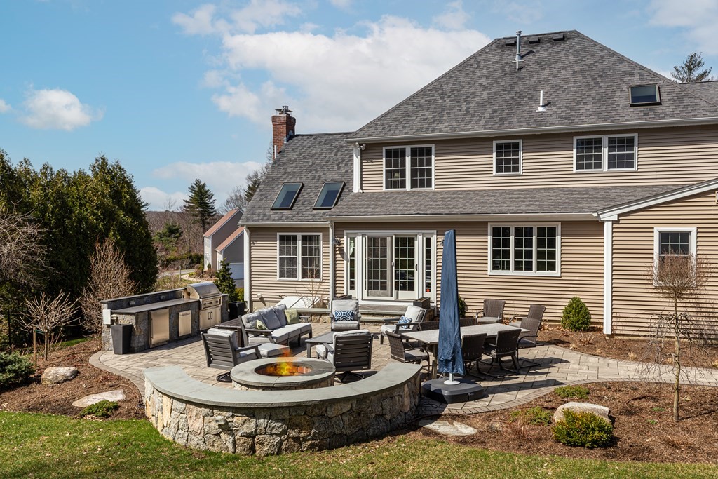 23 Pennock Road Ashland, MA 01721 - Photo 36 of 41 a backyard of a house with fire pit and outdoor seating