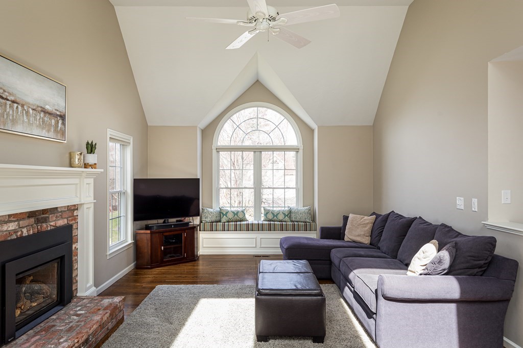 23 Pennock Road Ashland, MA 01721 - Photo 8 of 41 a living room with furniture a fireplace and a flat screen tv