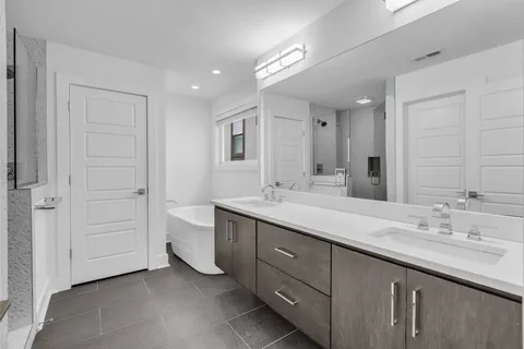 a bathroom with a double vanity sink and a mirror