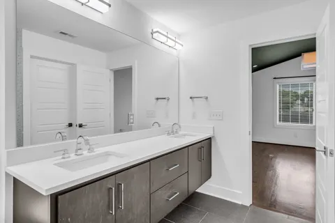 a bathroom with a sink double vanity and a mirror