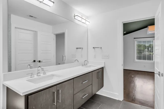 a bathroom with a sink double vanity and a mirror