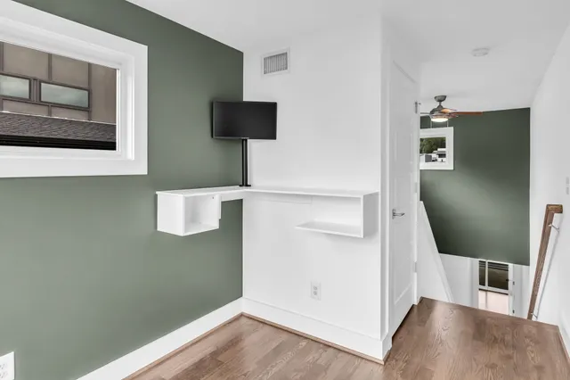 a view of a livingroom with wooden floor and cabinet