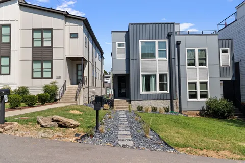 a front view of a house with garden