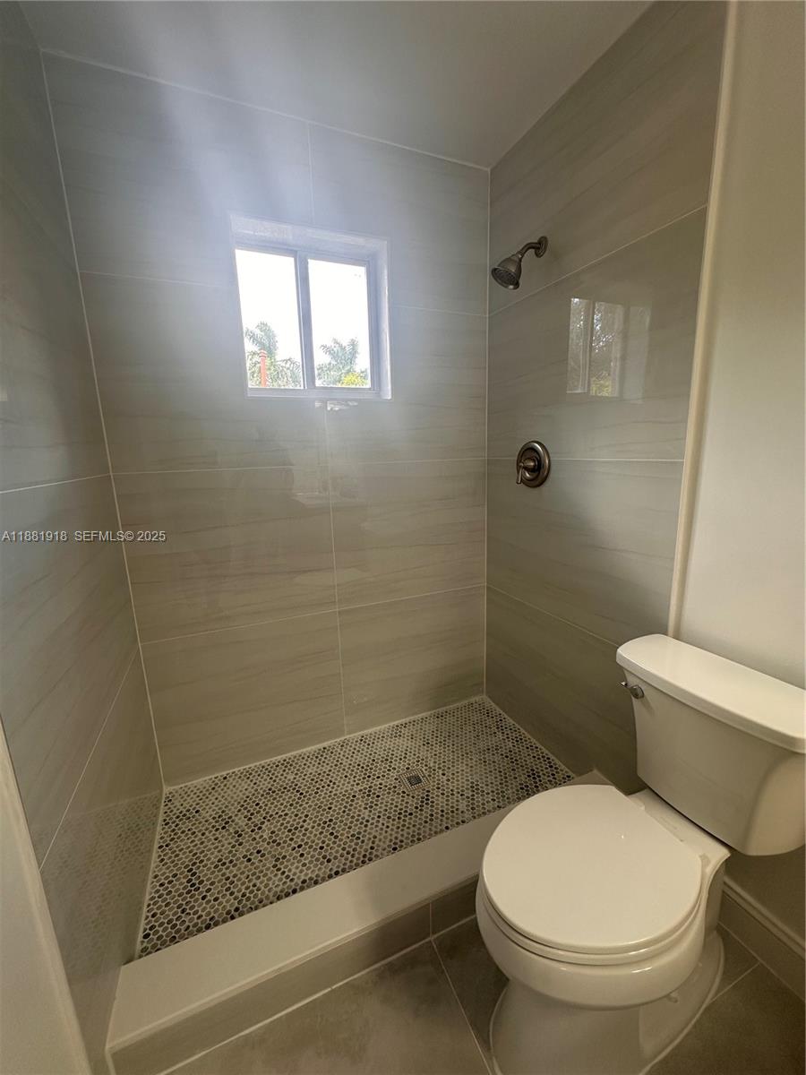 8950 Northwest 189th Terrace Hialeah, FL 33018 - Photo 17 of 42 a bathroom with a toilet and a shower