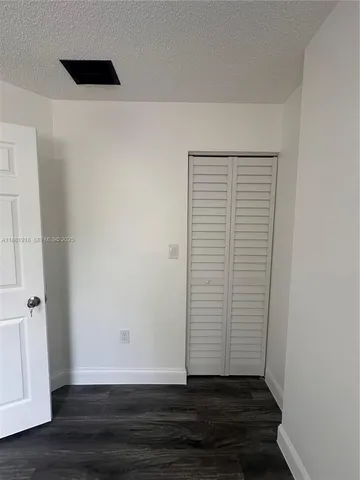 a view of walk in closet with wooden floor