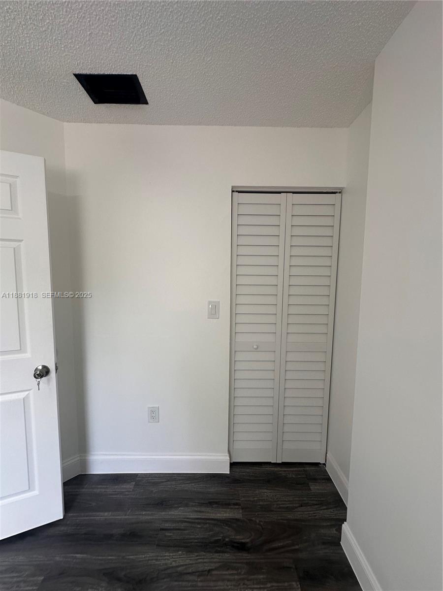8950 Northwest 189th Terrace Hialeah, FL 33018 - Photo 24 of 42 a view of an empty room with wooden floor and a window