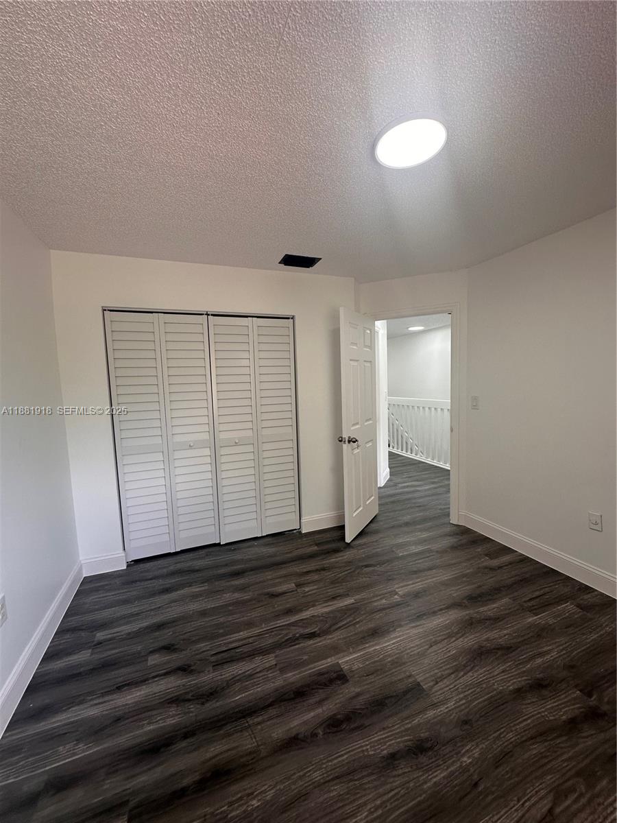 8950 Northwest 189th Terrace Hialeah, FL 33018 - Photo 28 of 42 a view of an empty room with wooden floor and a window