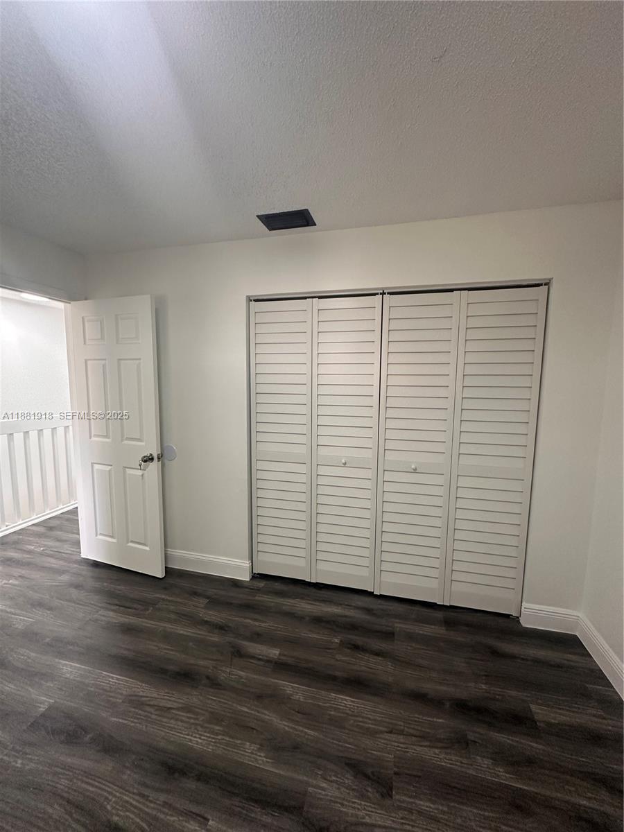 8950 Northwest 189th Terrace Hialeah, FL 33018 - Photo 31 of 42 a view of empty room with wooden floor