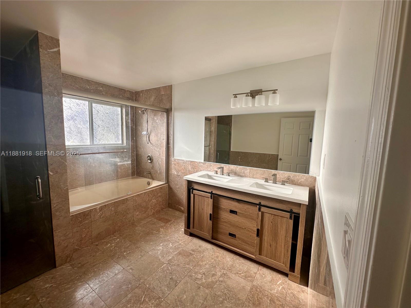 8950 Northwest 189th Terrace Hialeah, FL 33018 - Photo 35 of 42 a bathroom with a granite countertop sink and a mirror