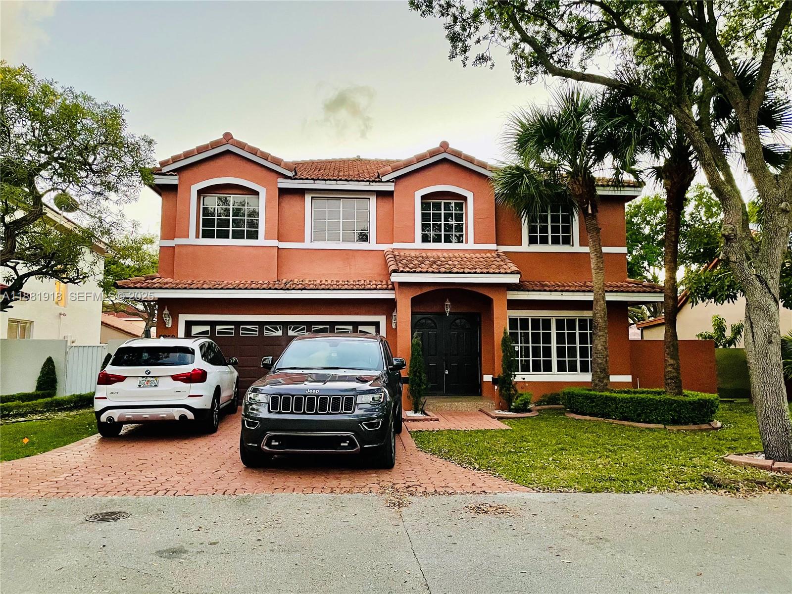 8950 Northwest 189th Terrace Hialeah, FL 33018 - Photo 42 of 42 a car parked in front of a house