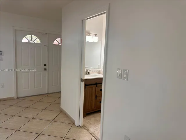 a view of a hallway to rooms