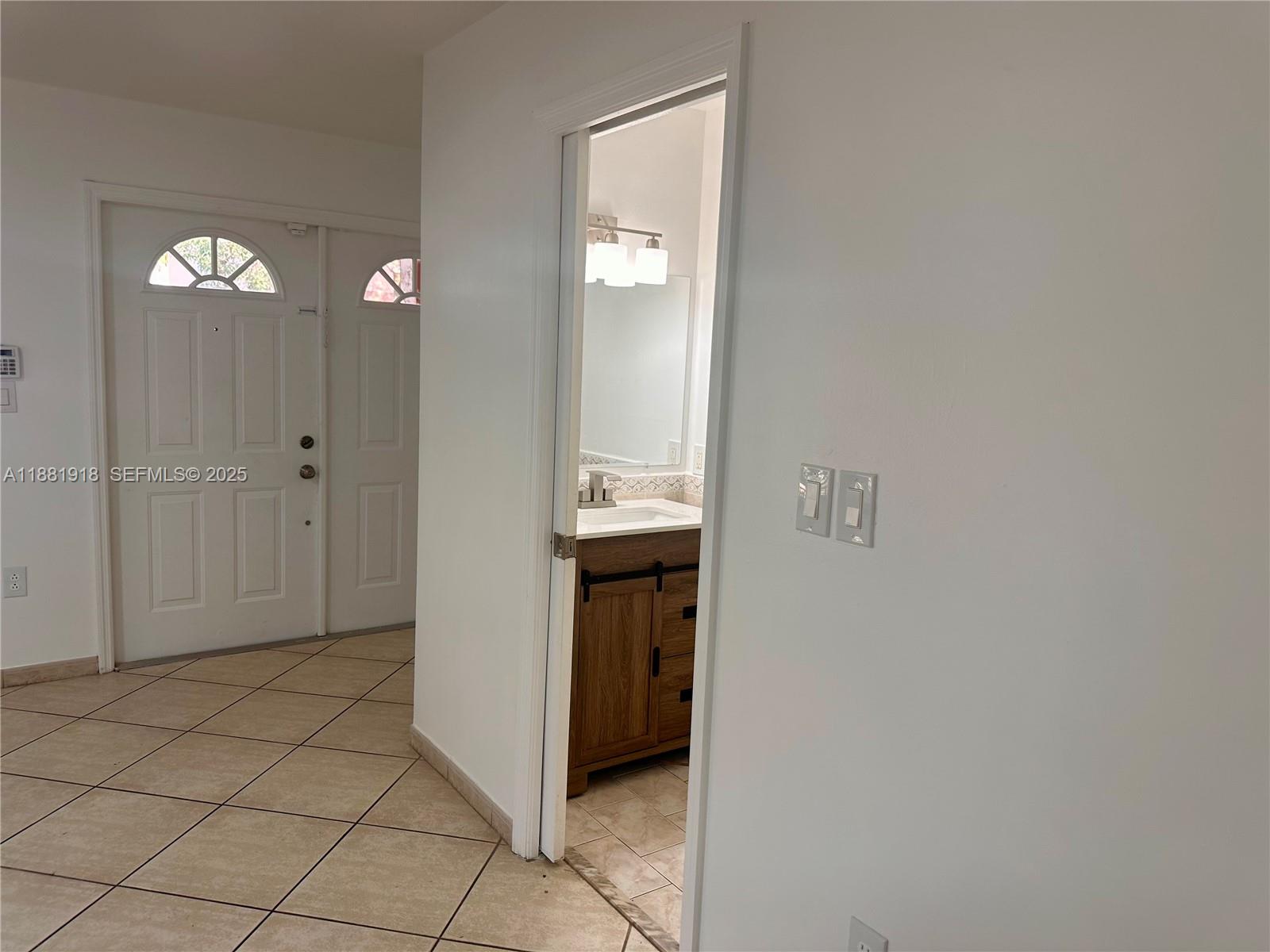 8950 Northwest 189th Terrace Hialeah, FL 33018 - Photo 9 of 42 a view of a hallway to rooms