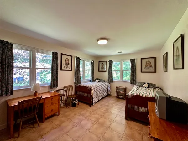 a spacious bedroom with a bed and a couch