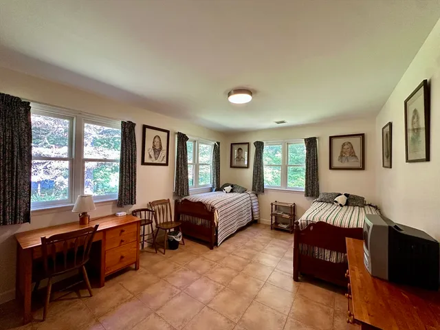 a spacious bedroom with a bed and a couch