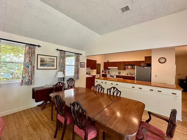 a view of a dining room with furniture and window