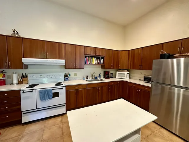 a kitchen with a white stove top oven and refrigerator
