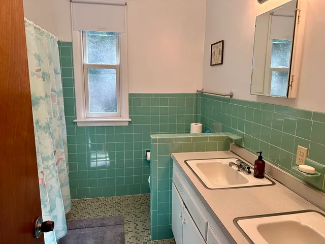 a bathroom with a sink a toilet and a mirror