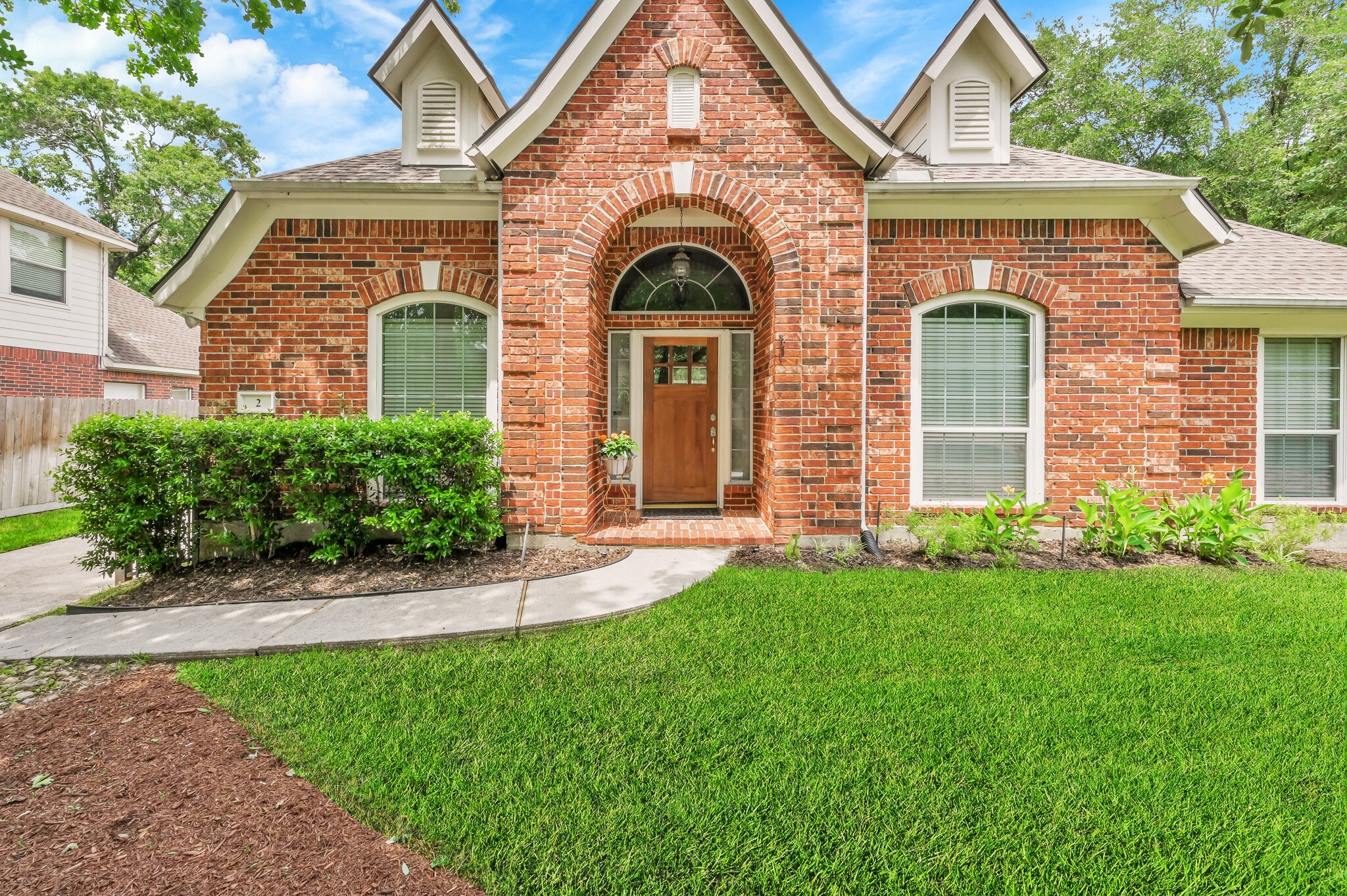 Stately brick home with arched front porch