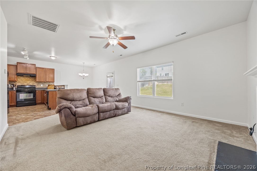 226 River Oak Street Spring Lake, NC 28390 - Photo 10 of 41 a living room with furniture and kitchen view