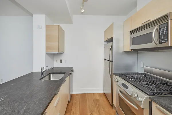a kitchen with a sink stove and refrigerator