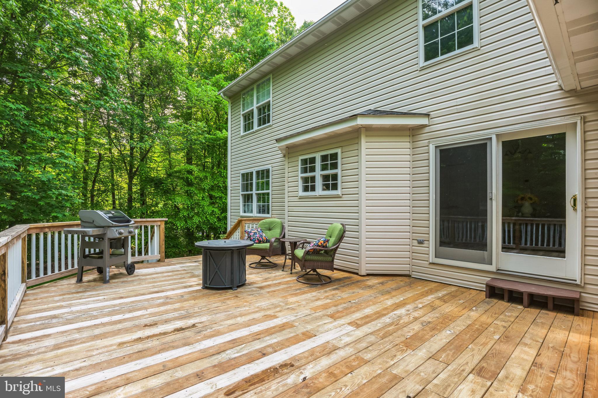 680 Small Reward Road Huntingtown, MD 20639 - Photo 30 of 40 a backyard of a house with table and chairs