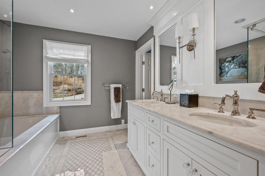 290 Old Comers Road Chatham, MA 02633 - Photo 14 of 40 a spacious bathroom with double vanity a mirror a vanity and a shower