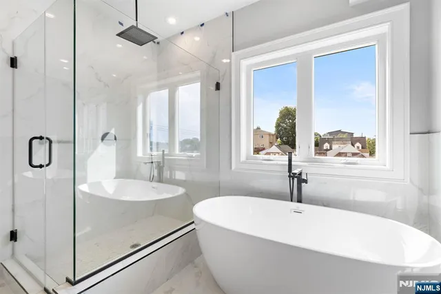 a white bath tub sitting next to a white sink