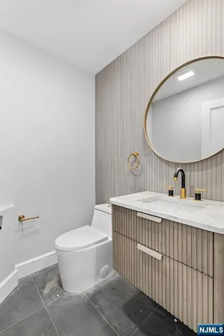 a bathroom with a toilet a sink and mirror