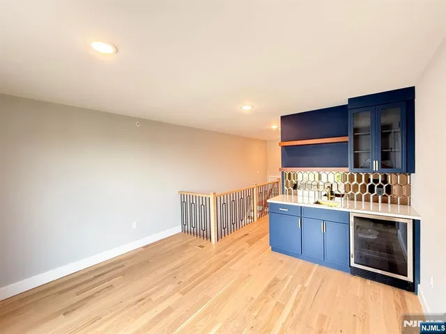 a kitchen with stainless steel appliances wooden cabinets and stove top oven