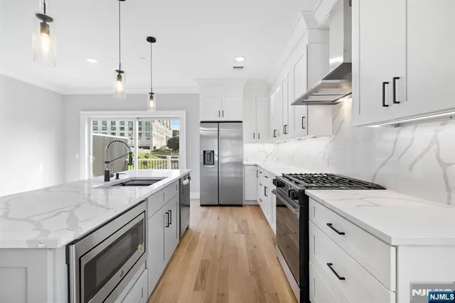 a kitchen with a stove oven and sink