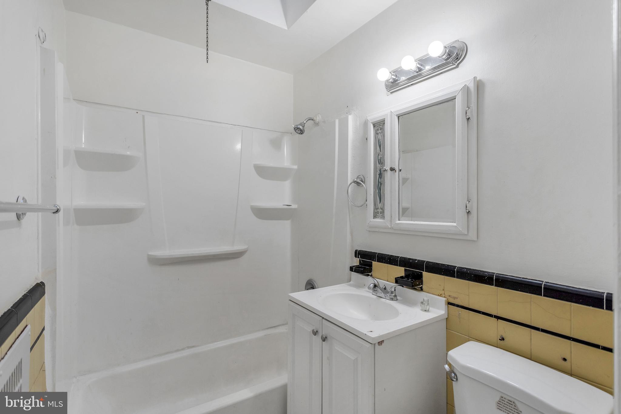 7249 Spruce Street Upper Darby, PA 19082 - Photo 15 of 30 a bathroom with a sink toilet vanity and tub