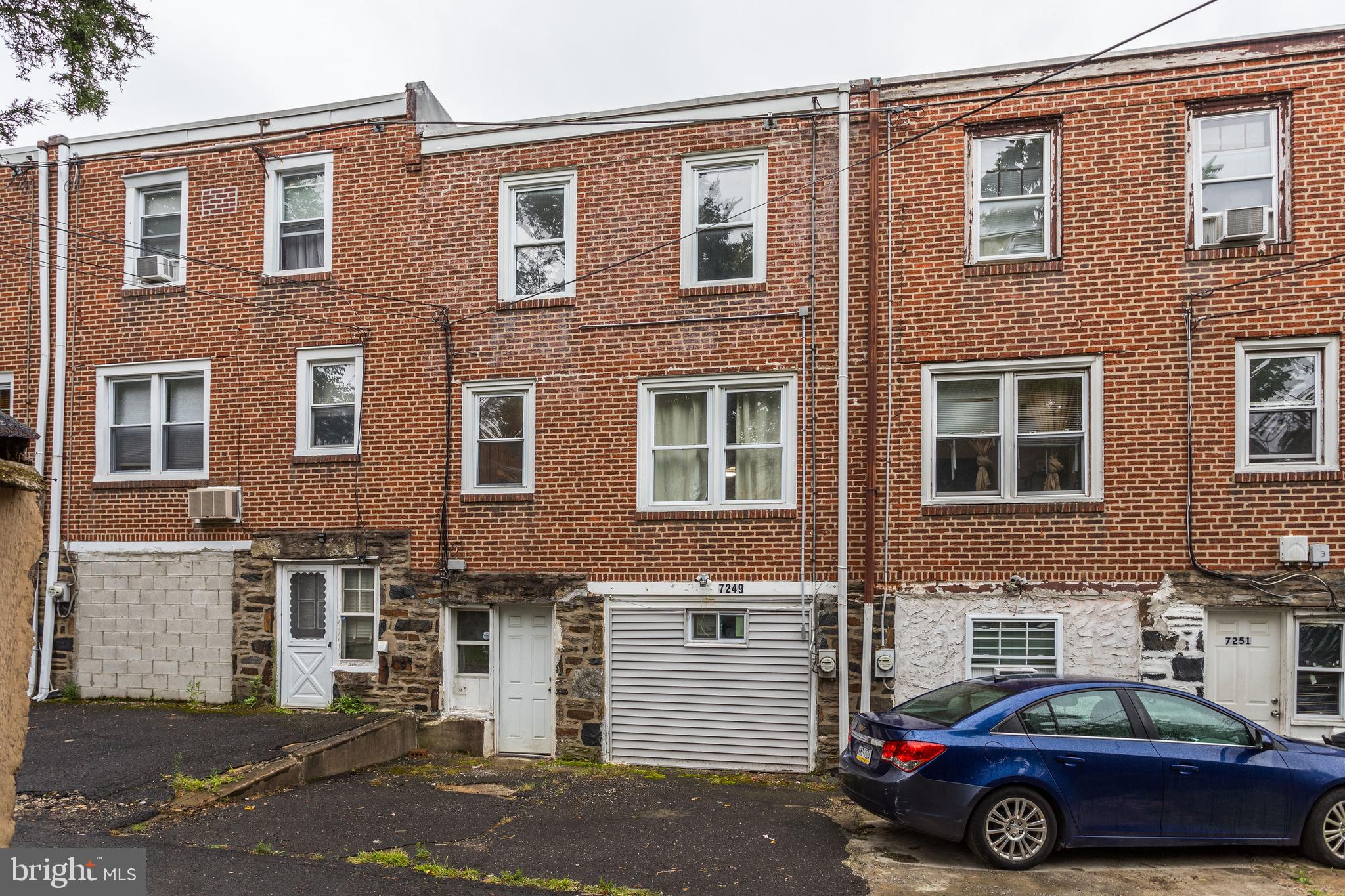 7249 Spruce Street Upper Darby, PA 19082 - Photo 29 of 30 a car parked in front of a brick building