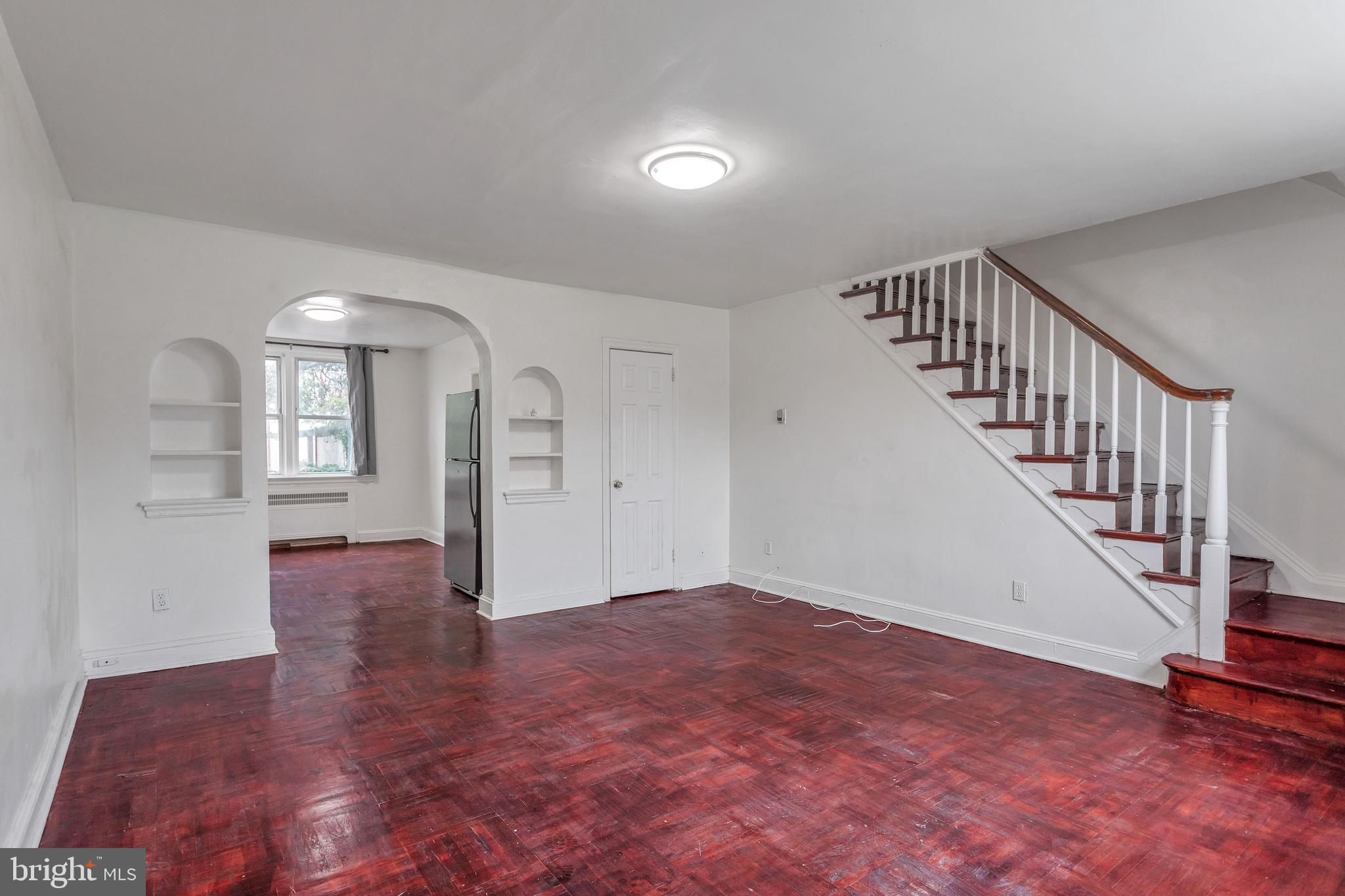 7249 Spruce Street Upper Darby, PA 19082 - Photo 4 of 30 a view of empty room with wooden floor and stairs