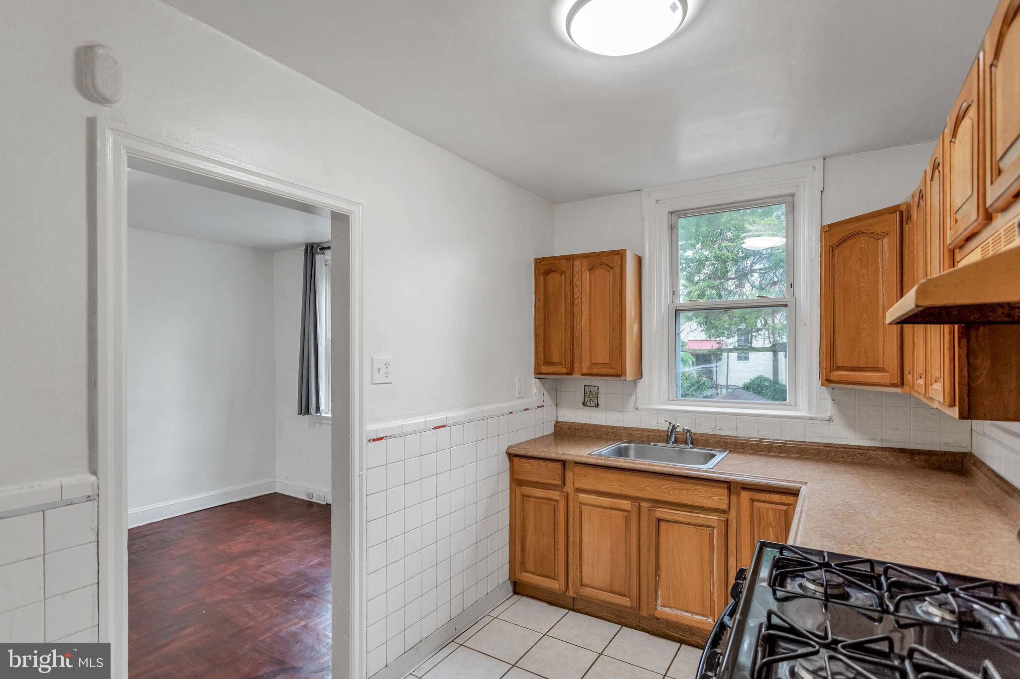 7249 Spruce Street Upper Darby, PA 19082 - Photo 9 of 30 a kitchen with stainless steel appliances granite countertop a stove a sink and a microwave