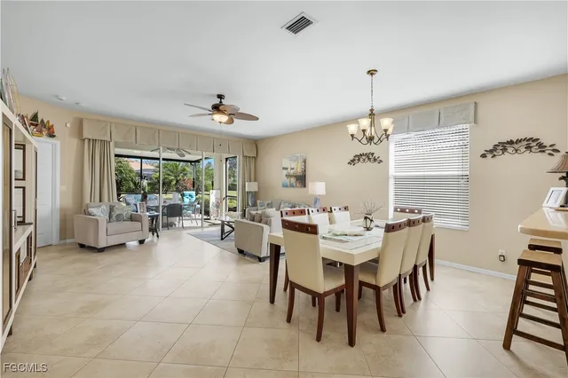 a view of a dining room with furniture and a chandelier