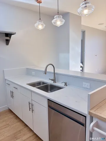 a kitchen with a sink cabinets and window