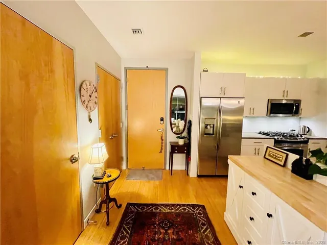 a kitchen with a refrigerator and a stove
