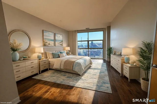 a spacious bedroom with a large bed and a large window