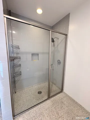 a bathroom with a glass shower door