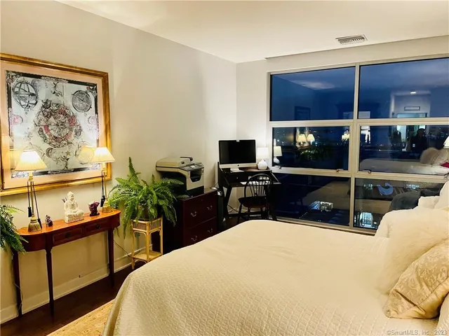 a bedroom with a bed and a television