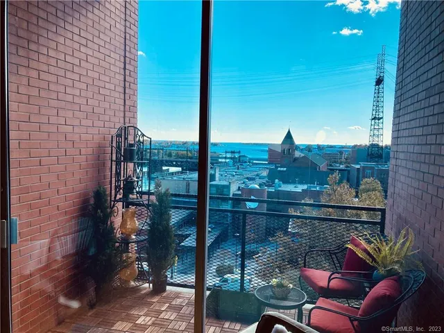 a view of a balcony with furniture