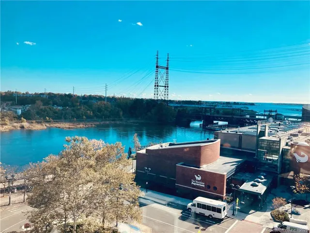 a view of a lake with couches in the patio