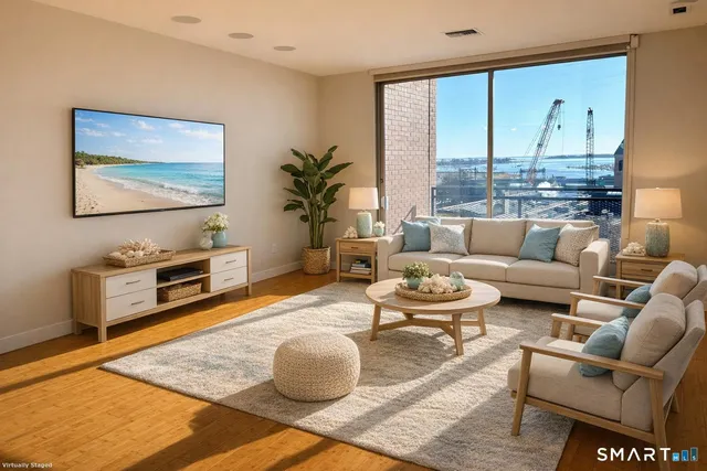 a living room with furniture a large window and a flat screen tv