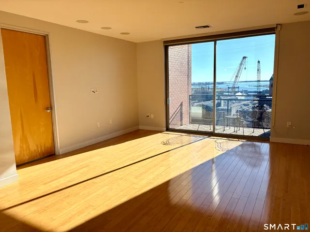 a view of a room with wooden floor and a window