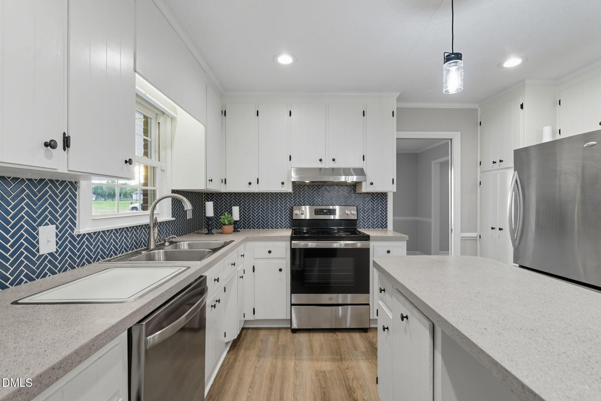 2238 Tarboro Road Youngsville, NC 27596 - Photo 13 of 41 a kitchen with a sink a stove a refrigerator and cabinets