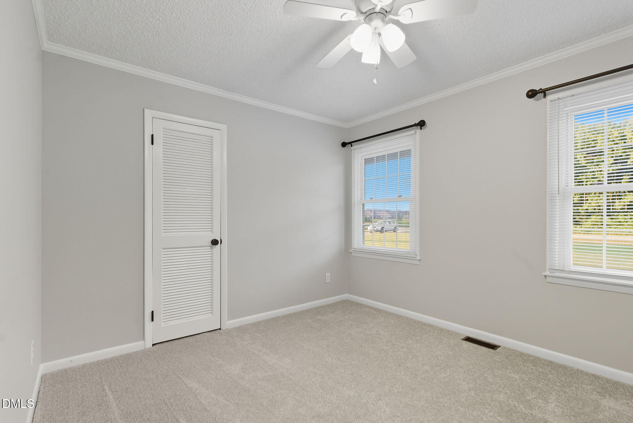 2238 Tarboro Road Youngsville, NC 27596 - Photo 29 of 41 an empty room with windows and fan