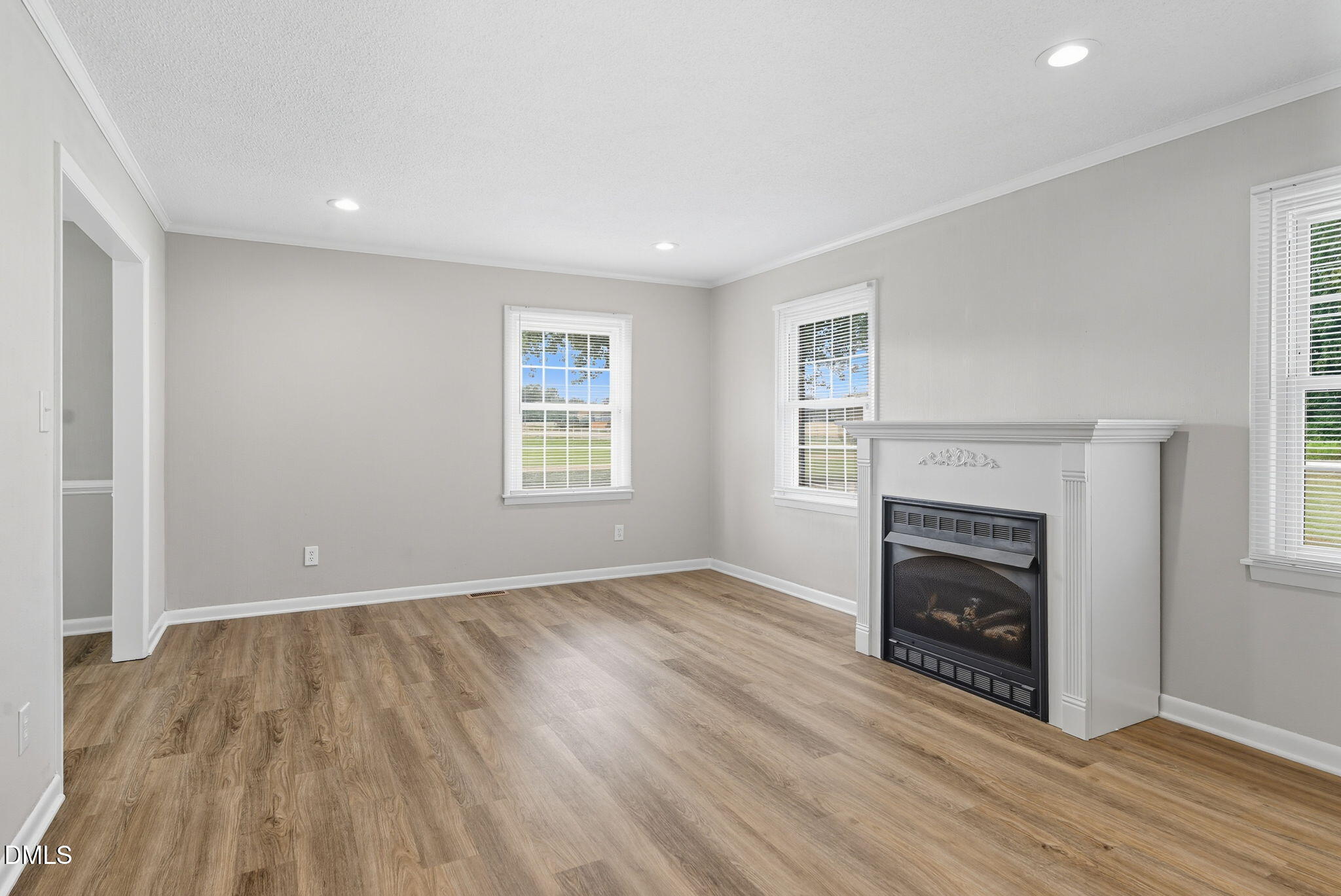 2238 Tarboro Road Youngsville, NC 27596 - Photo 9 of 41 an empty room with windows and fireplace