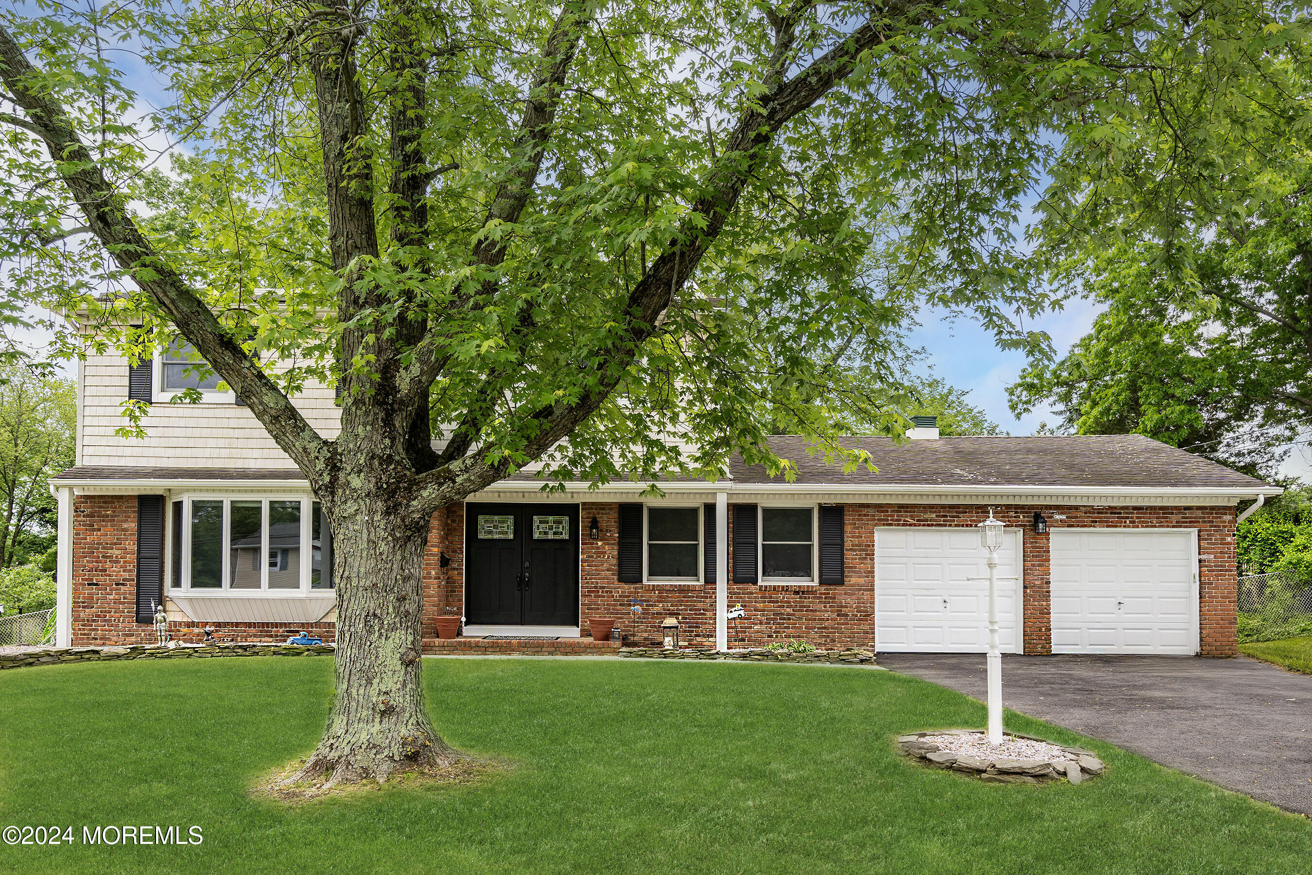 59 Westbrook Road Howell, NJ 07731 - Photo 3 of 35 a front view of a house with a garden and yard