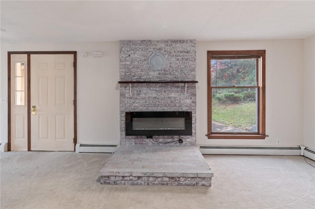21 Maple Street Lyons, NY 14489 - Photo 13 of 37 The view of the linear fireplace and exit to the T